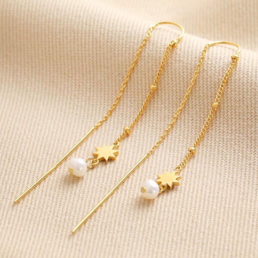 Thread Through Star and Pearl Chain Earrings in Gold on Beige Fabric