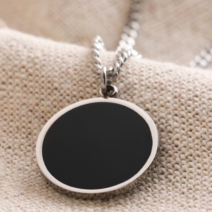 A Round Black Pendant on a Stainless Steel Chain, Ideal for Gifting to a Stylish Man