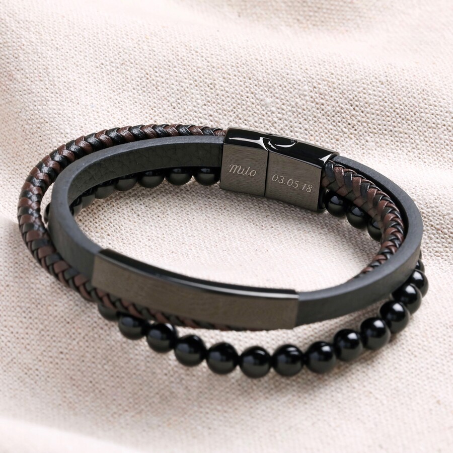 A Slick Black Leather Bracelet Layered With a Beaded Chain