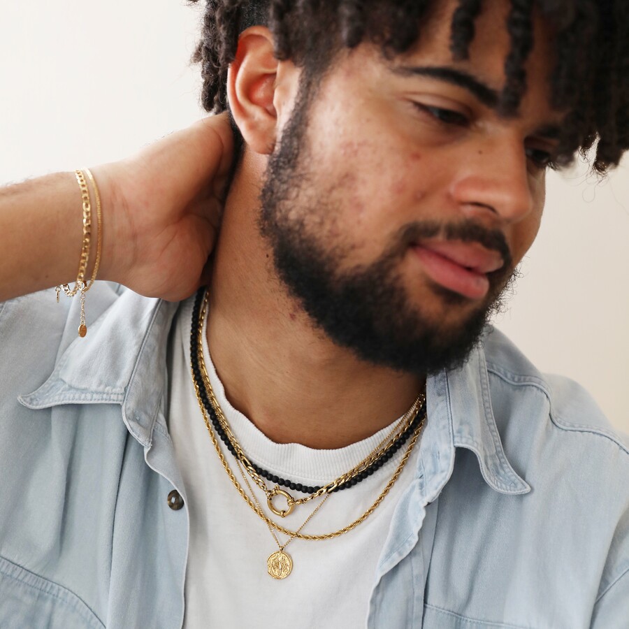 A st christopher necklace is ideal for layering as part of a cool unisex jewellery look