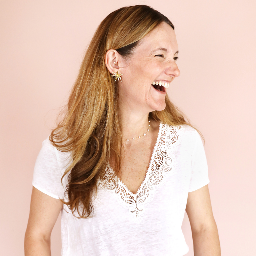 Lisa Angel Laughing in Front of Pink Background