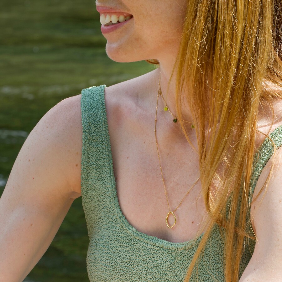 carly rowena wearing two gold necklaces in a layered style