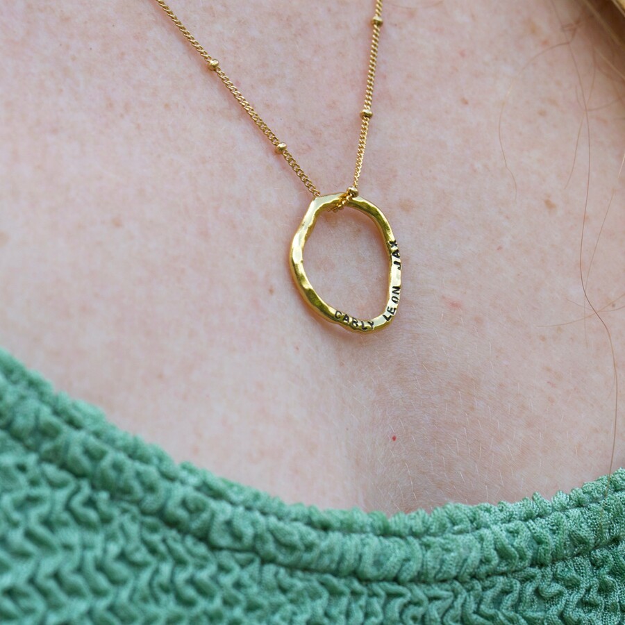 carly rowena's organic shaped godl necklace with her family names engraved