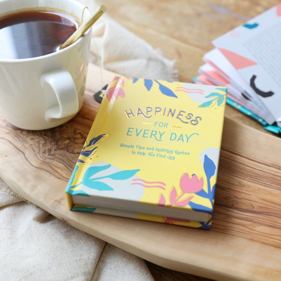 Happiness For Every Day Book on top of wooden coffee table