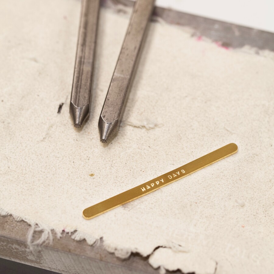 Hand Stamping Personalisation Method in Process on a Gold Band Ring