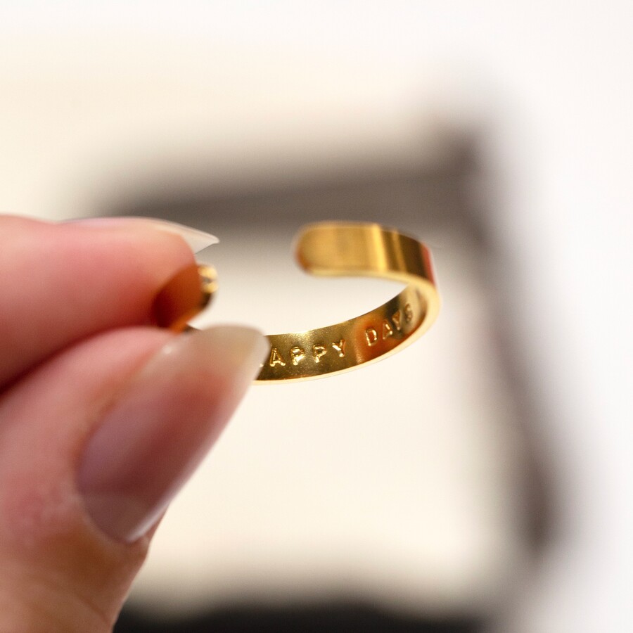 A Finished Hand Stamping Personalisation on a Gold Band Ring