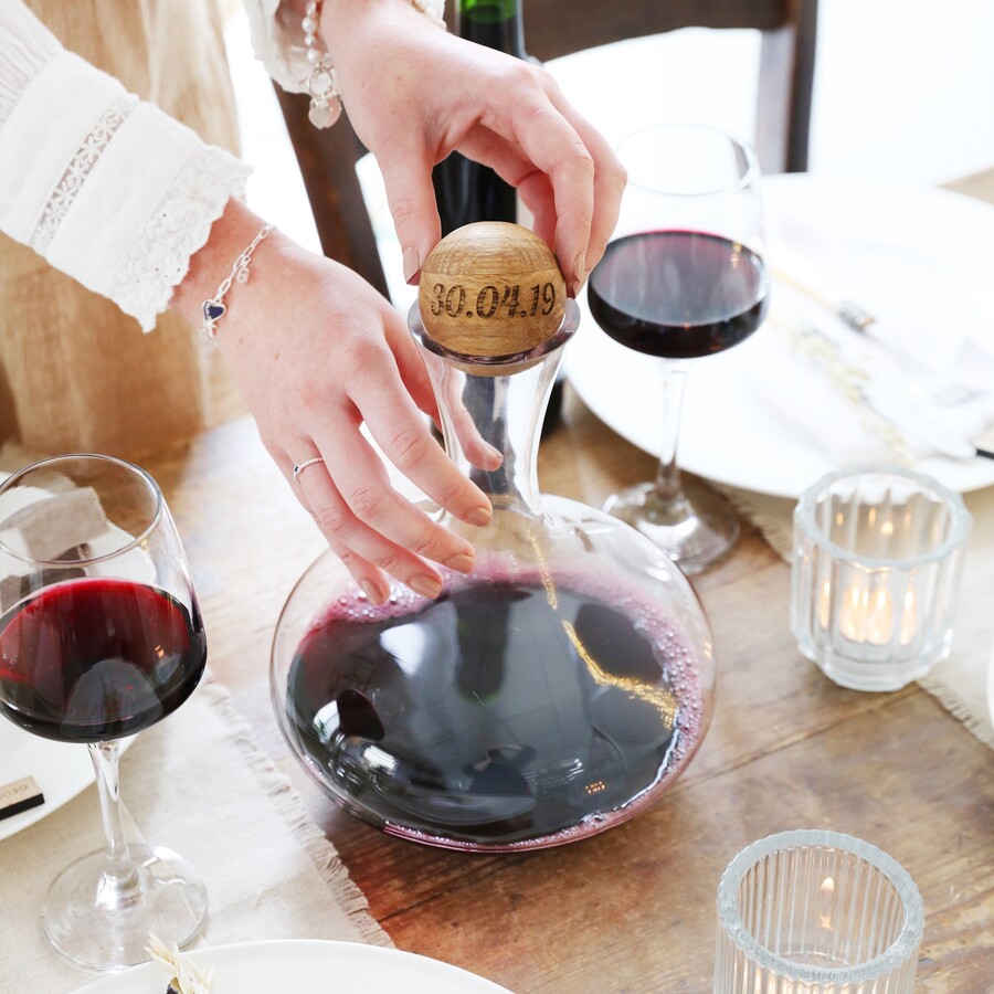 A Glass Carafe Bottle With a Wooden Stopper