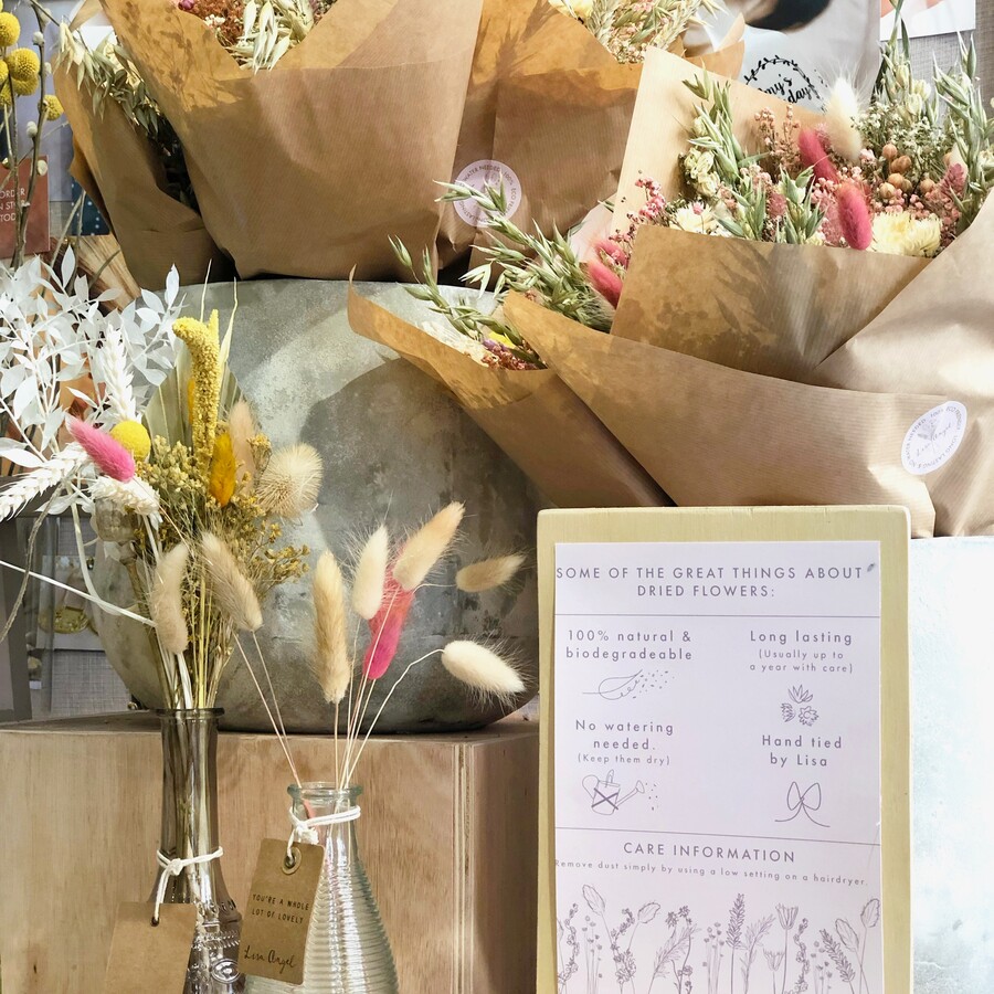 a range of different textured dried flowers wrapped in paper