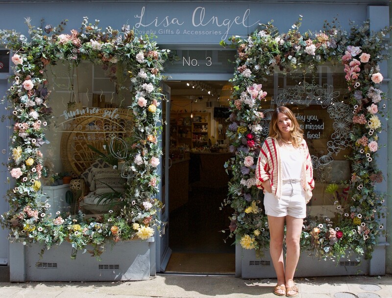 Lisa standing outside shop with large floral display