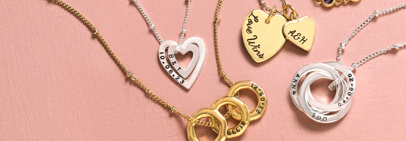 Model Holding Personalised Double Heart Charm Necklace