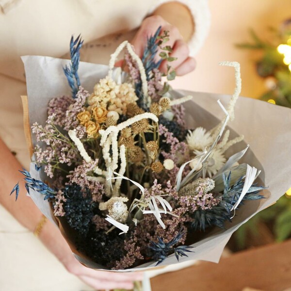 Model holding luxury midwinter dried flower bouquet