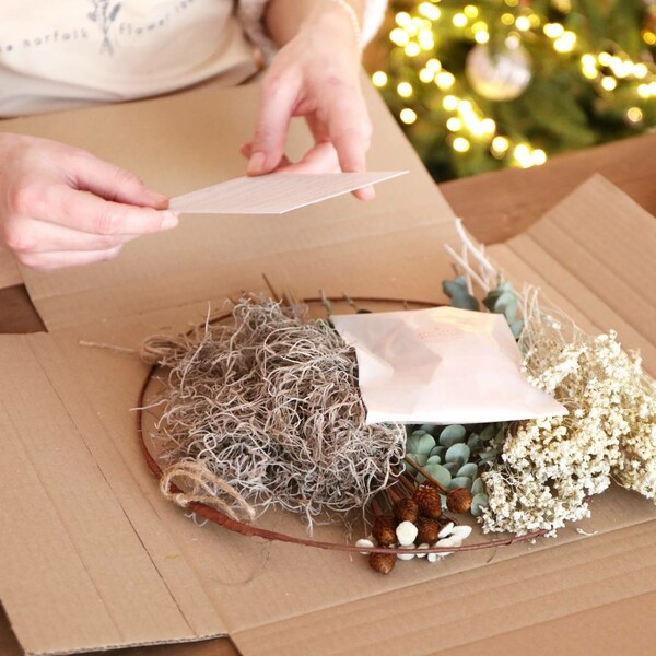 Gingerbread Christmas Dried Flower Wreath Making Kit open with model holding instructions card 