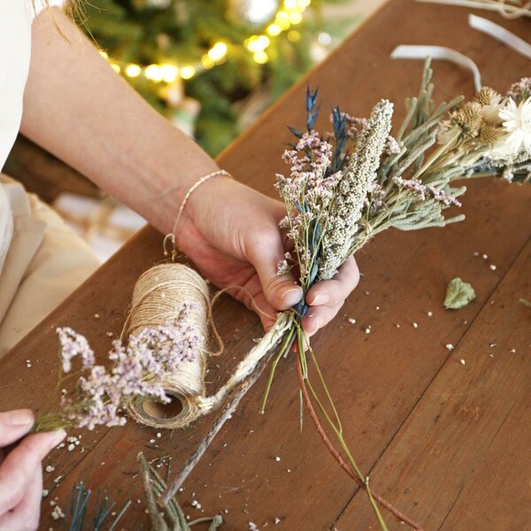 Model holding flowers out of Luxury Midwinter Dried Flower Bouquet