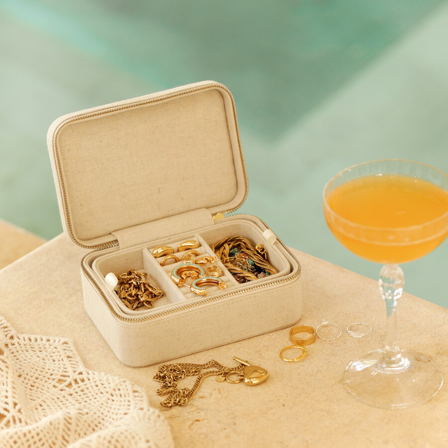 Jewellery Case with drink and jewellery next to pool