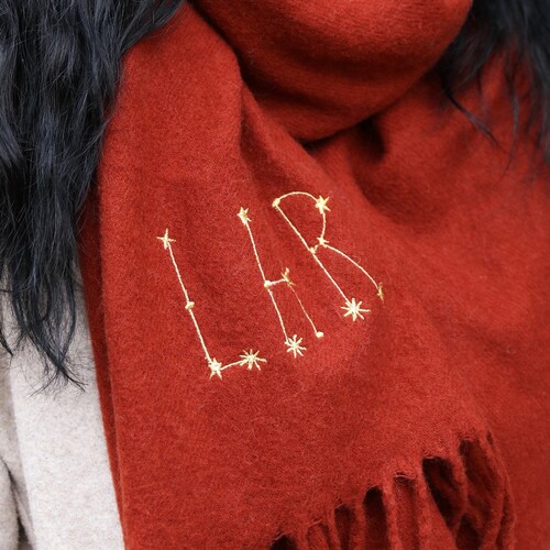 red personlised lambswool scarf embroidered with LHR in constellation lettering