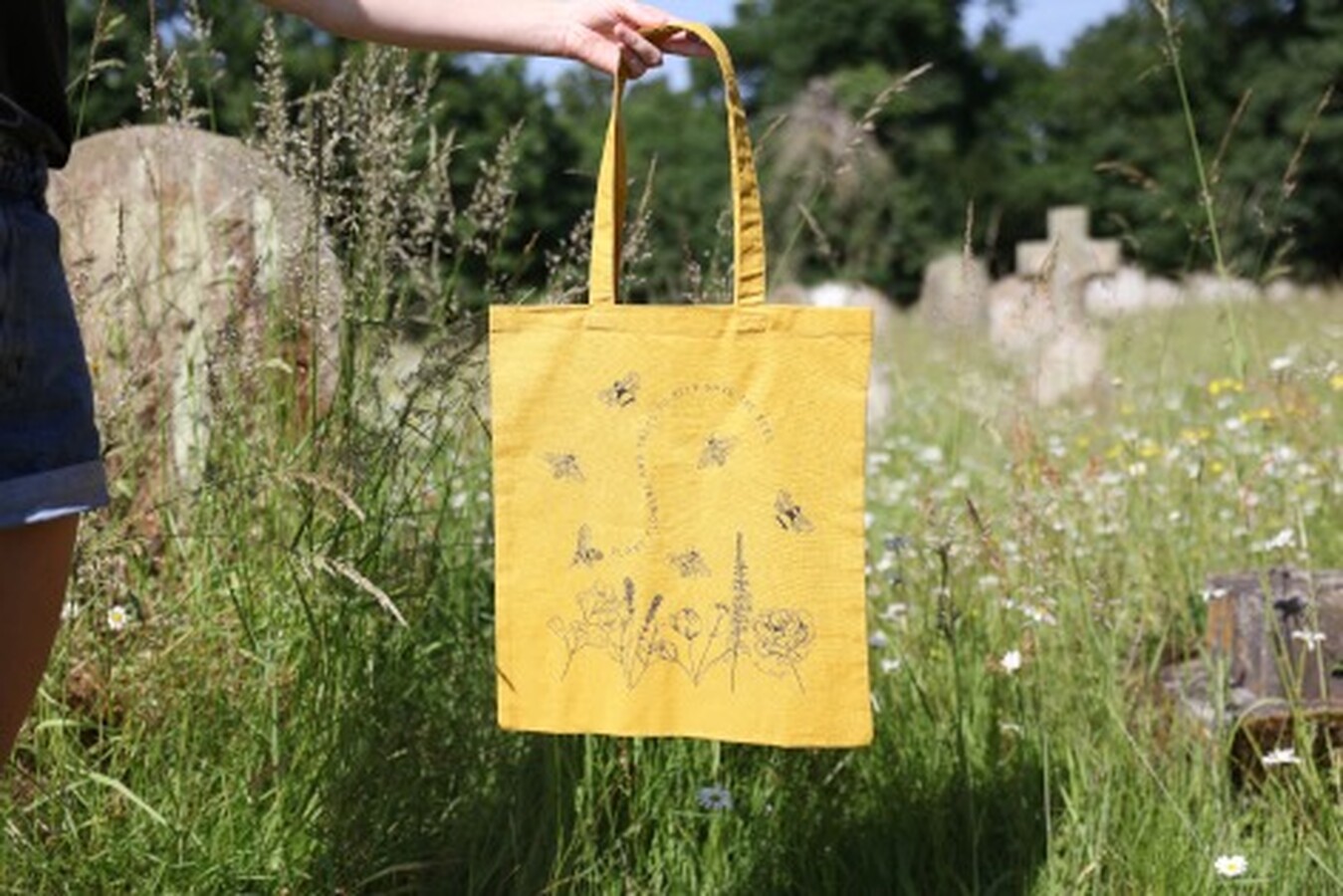 a yellow cotton tote bag that has save the bees wording and pattern