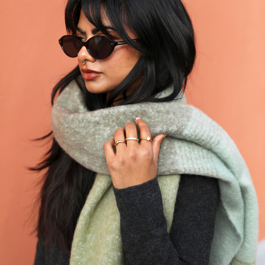A Folded Winter Scarf Made up of Brown and Blue Tones in a Fine Check Print