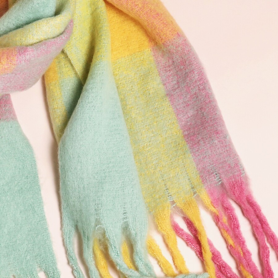 Close Up of the Pretty Pastel Pink Yellow and Blue Pattern on a Thick Wintry Woollen Scarf with Tassels