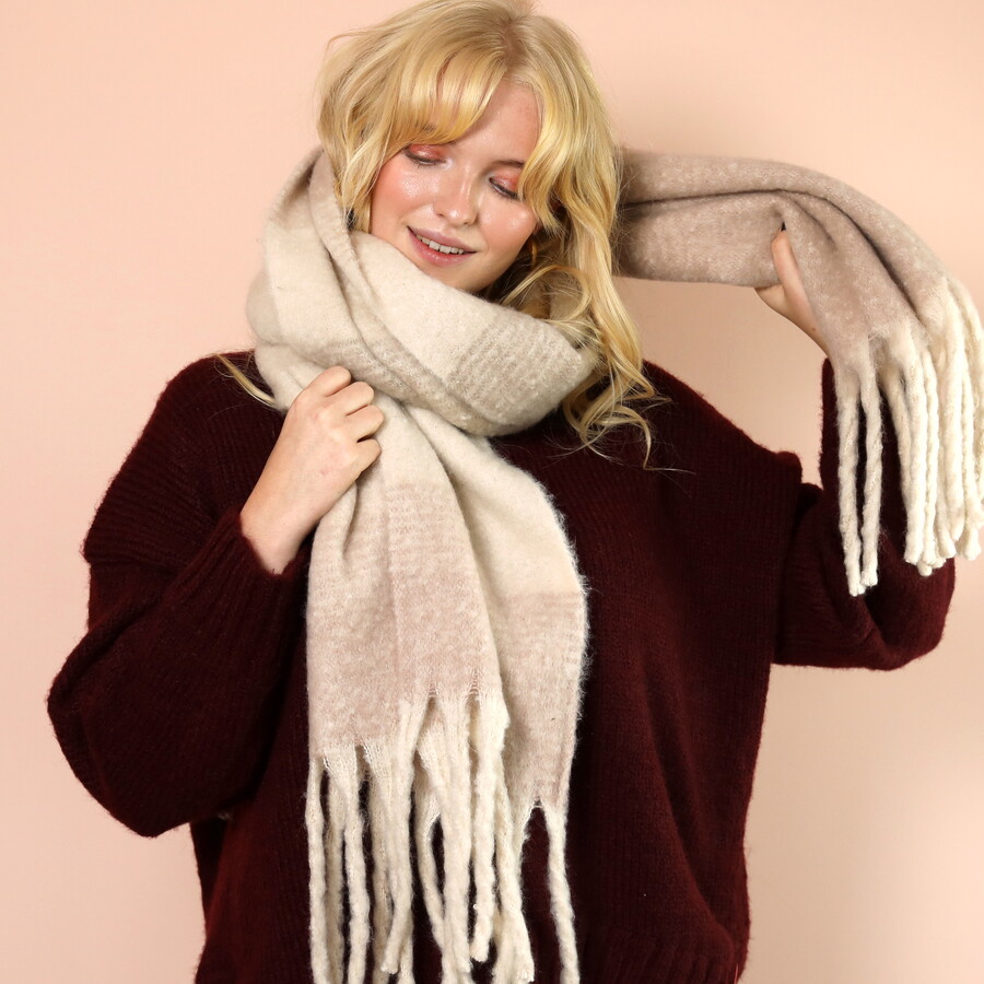 Model wearing soft and timeless neutral scarf against a dark berry red jumper to stand out