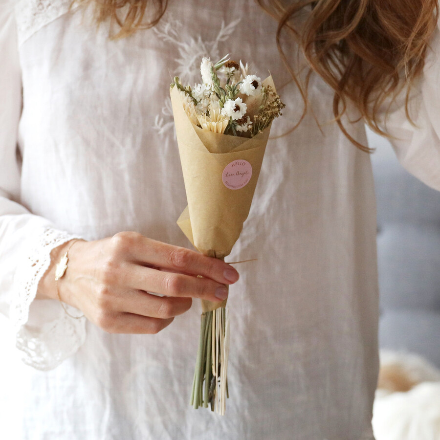 A Beautiful Neutral Toned Dried Flower Posy Wrapped in Paper Being Held by a Mother