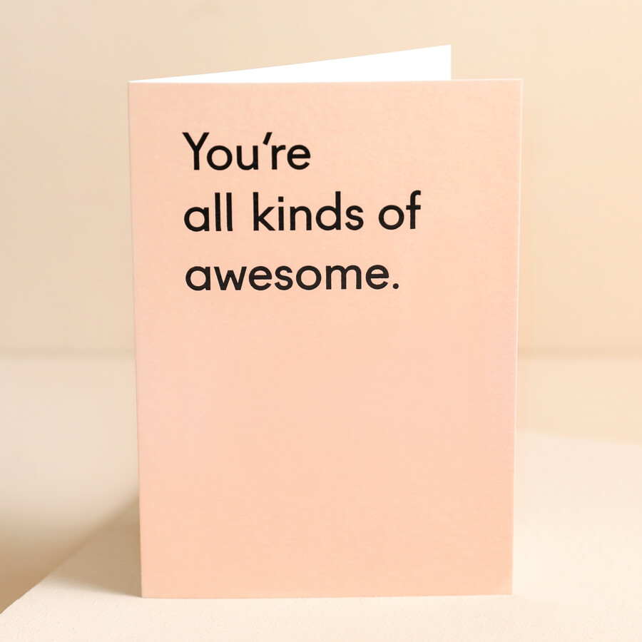 A Pale Pink Greetings Card With 'You're Awesome' Thank You Message in Black Text on the Front