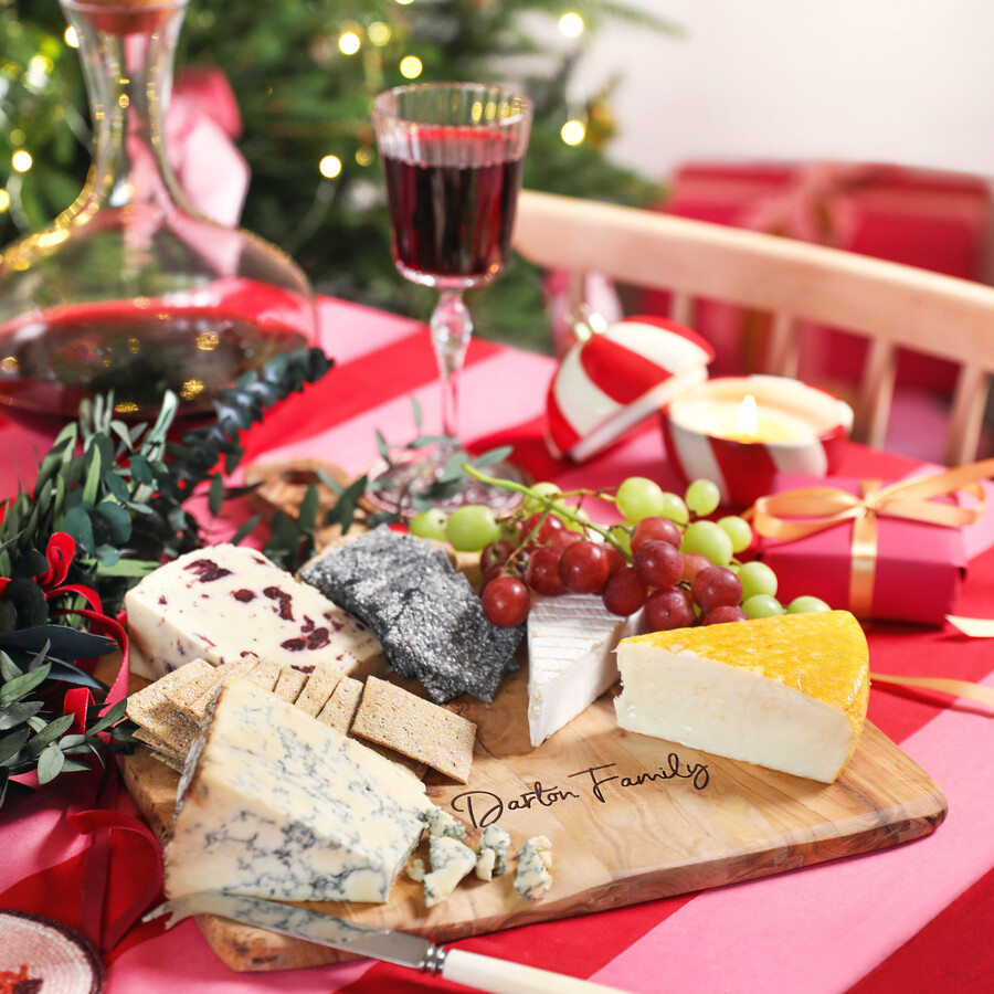 A Christmas Tablescape Filled with Colourful Materials and a Personalised Cheeseboard
