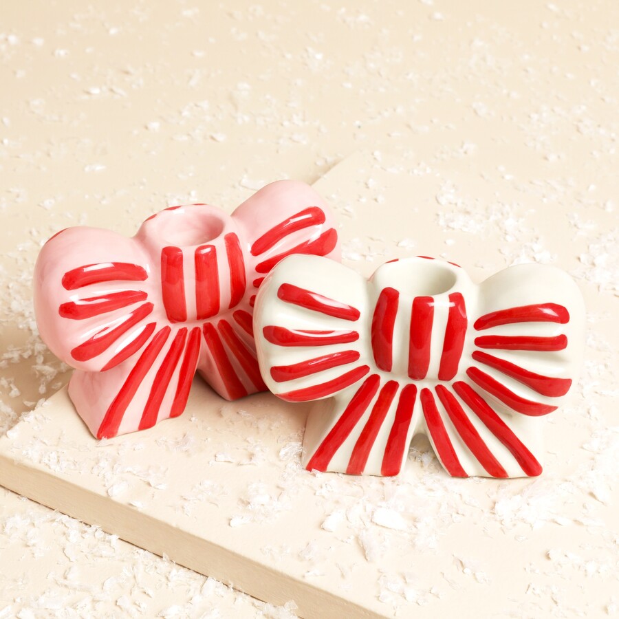 A Pair of Ceramic Bow-Shaped Candle Holders With Pink and red or White and red Stripes
