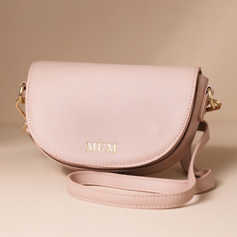 A Small Pink Faux Leather Satchel Bag With Mum Lettering Pressed Into the Front