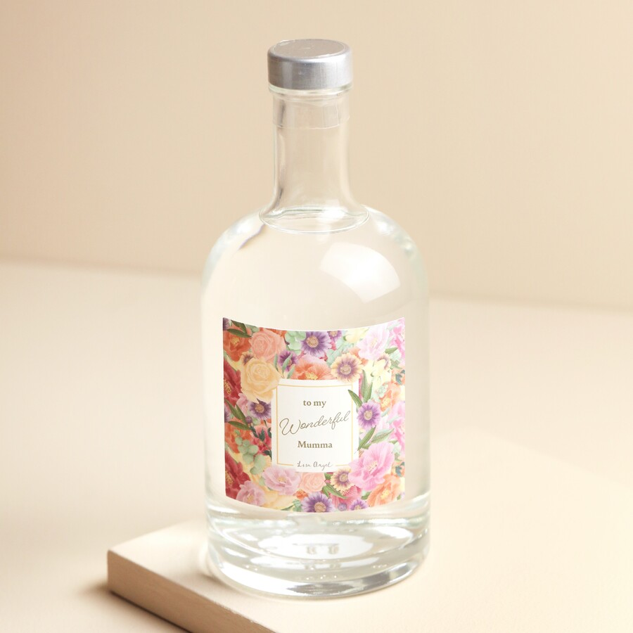 A Glass Bottle Filled With Gin With a Pink Floral Label and To My Wonderful Mumma Wording