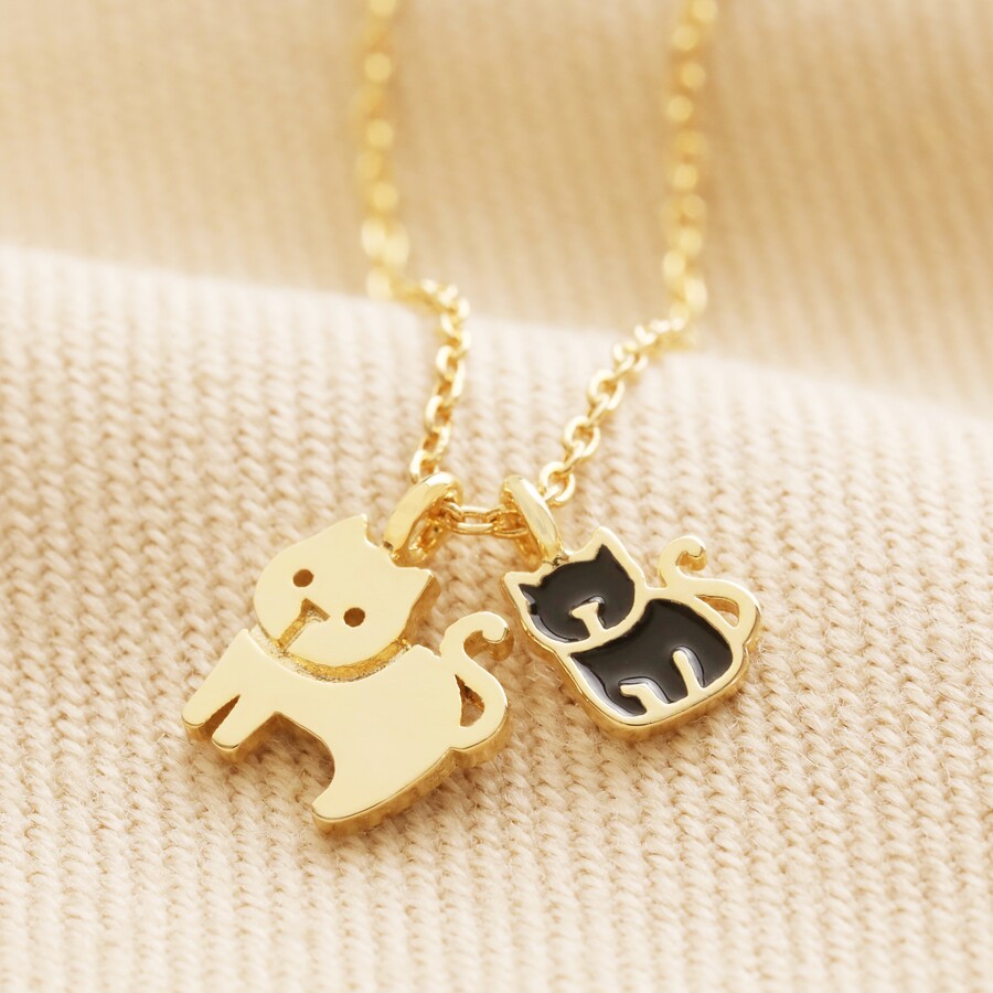 A Double Cat Pendant with Black enamel Infill on a Gold Chain