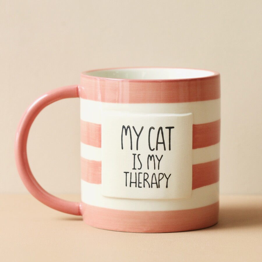 A Pink and White Striped Ceramic Mug With Cat Message on the Front