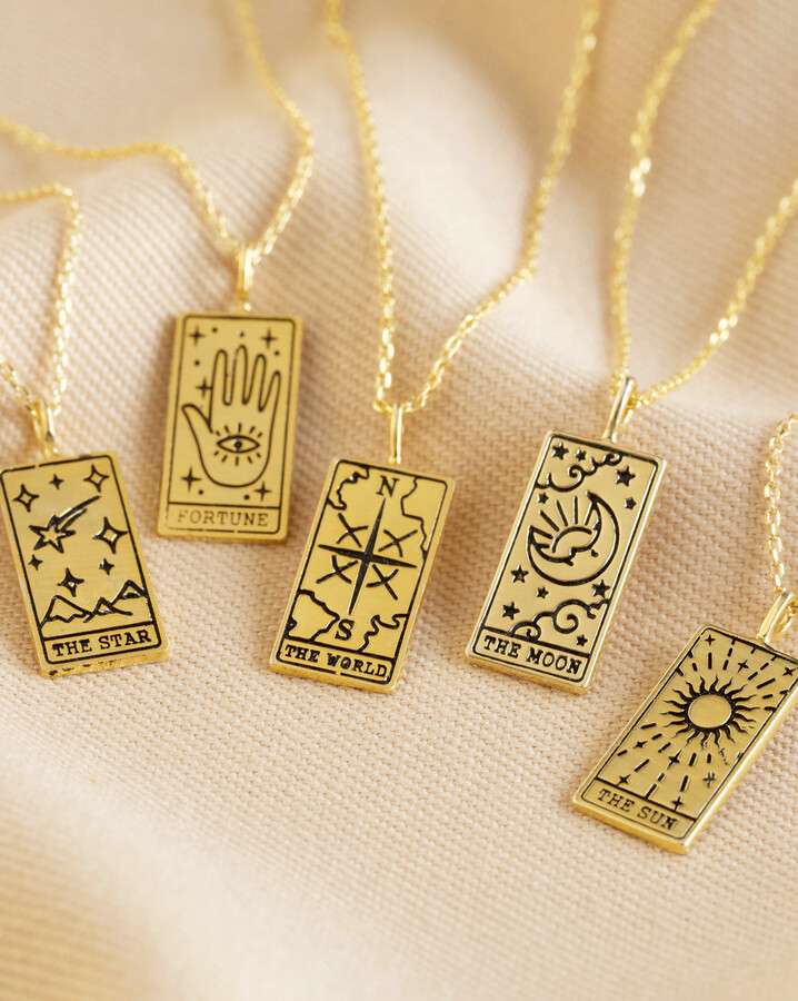 Group shot of gold tarot card pendant necklaces