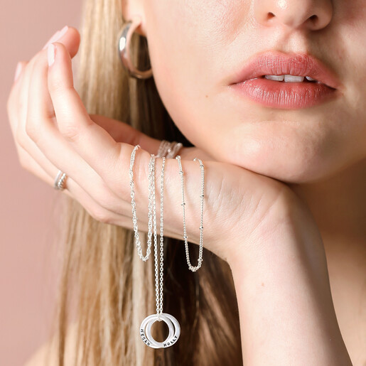 Model Holding Personalised Sterling Silver Interlocking Circles Necklace Model Holding Personalised Sterling Silver Interlocking Circles Necklace