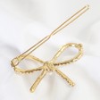 Back of Lisa Angel Ladies' Pearl Bow Hair Clip in Gold