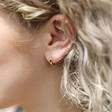 Tiny Gold Sterling Silver Huggie Hoop Earrings on Model