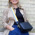 Lisa Angel Ladies' Black Leather Crossbody Bag with Blue and Mustard Striped Strap on Model