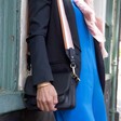 Lisa Angel Ladies' Black Leather Saddle Bag with Pink Strap on Model