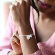Model wears Lisa Angel Personalised Sterling Silver Double Heart Charm Bracelet