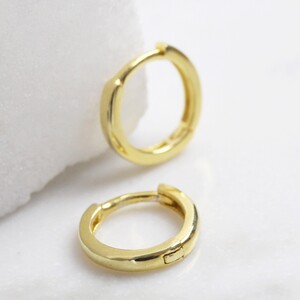 Small hoop sterling huggie earrings with gold plate. 