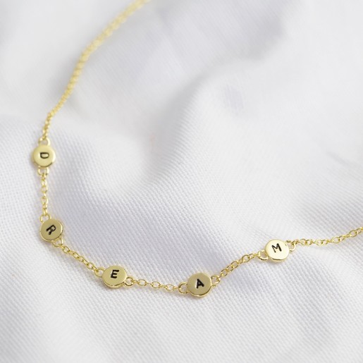 short gold necklace with charm