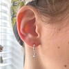 T-Rex Dinosaur Huggie Hoop Earrings in Silver on Model