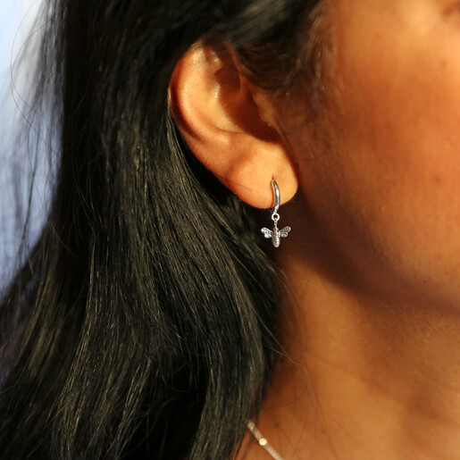 Tiny Bee Huggie Hoop Earrings in Silver on Model
