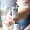 Koala Bottle Stopper Being Placed in Bottle by Model