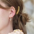 Crystal Eye Star and Moon Charm Hoop Earrings in Gold on Model