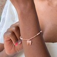 Stone Bead and Wing Charm Bracelet in Rose Gold on Model