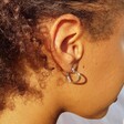 Organic Finish Small Heart Hoop Earrings in Silver on Model