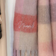 Close up of Personalised Embroidered Checkered Oversized Scarf in Red and Pink