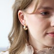 Ladies' Wide Irregular Shape Hoop Earrings in Gold on Model