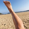 model on beach laying with foot in the air wearing Oversized Flat Curb Chain Anklet