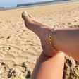 Oversized Flat Curb Chain Anklet on model with foot on knee on the beach